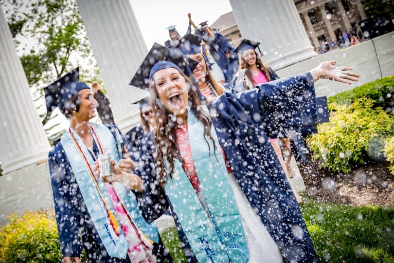 Graduate throwing confetti