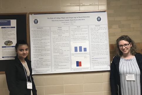 two students in front of poster