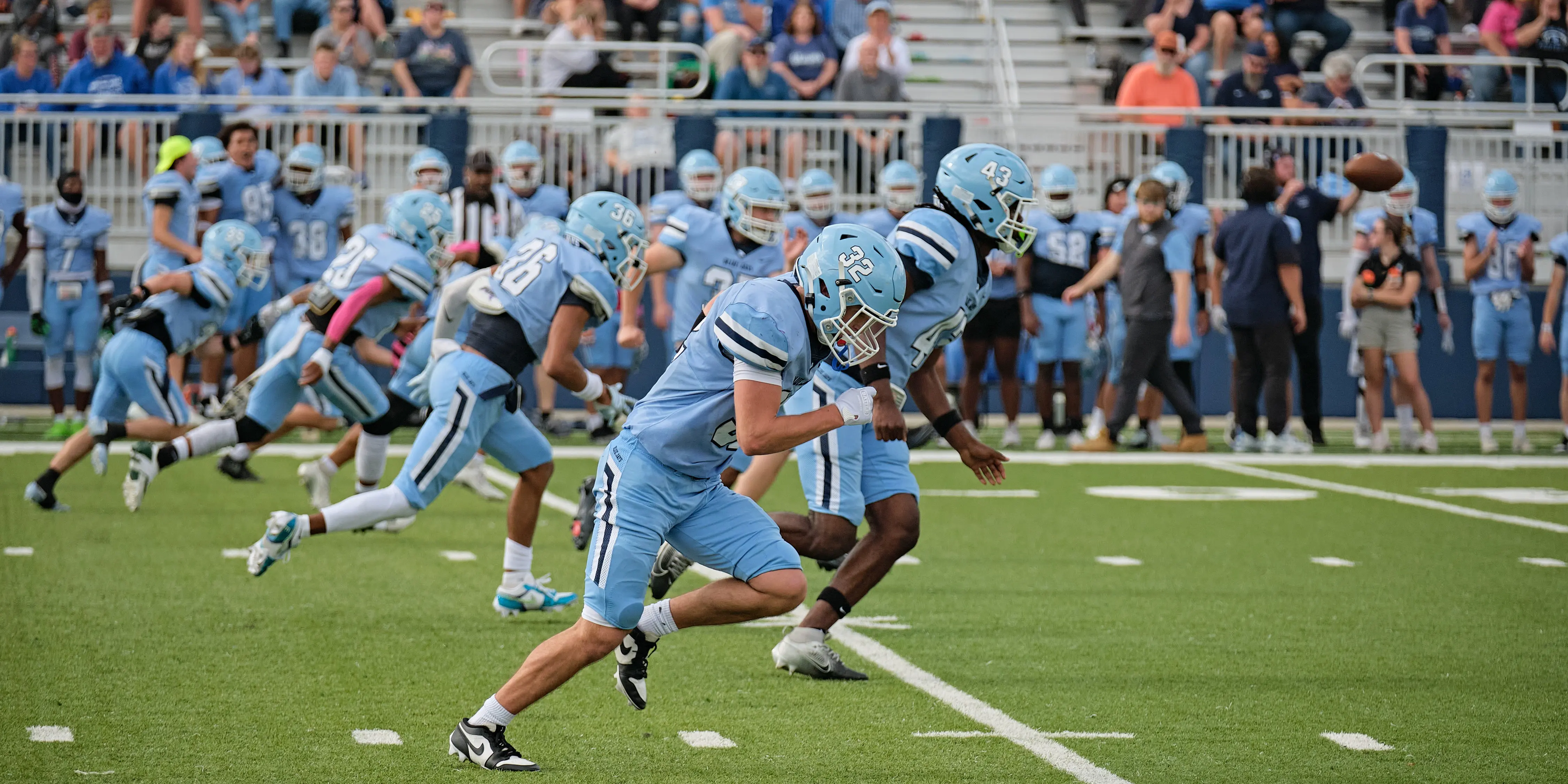 westminster college students playing football in a blue uniform on the field