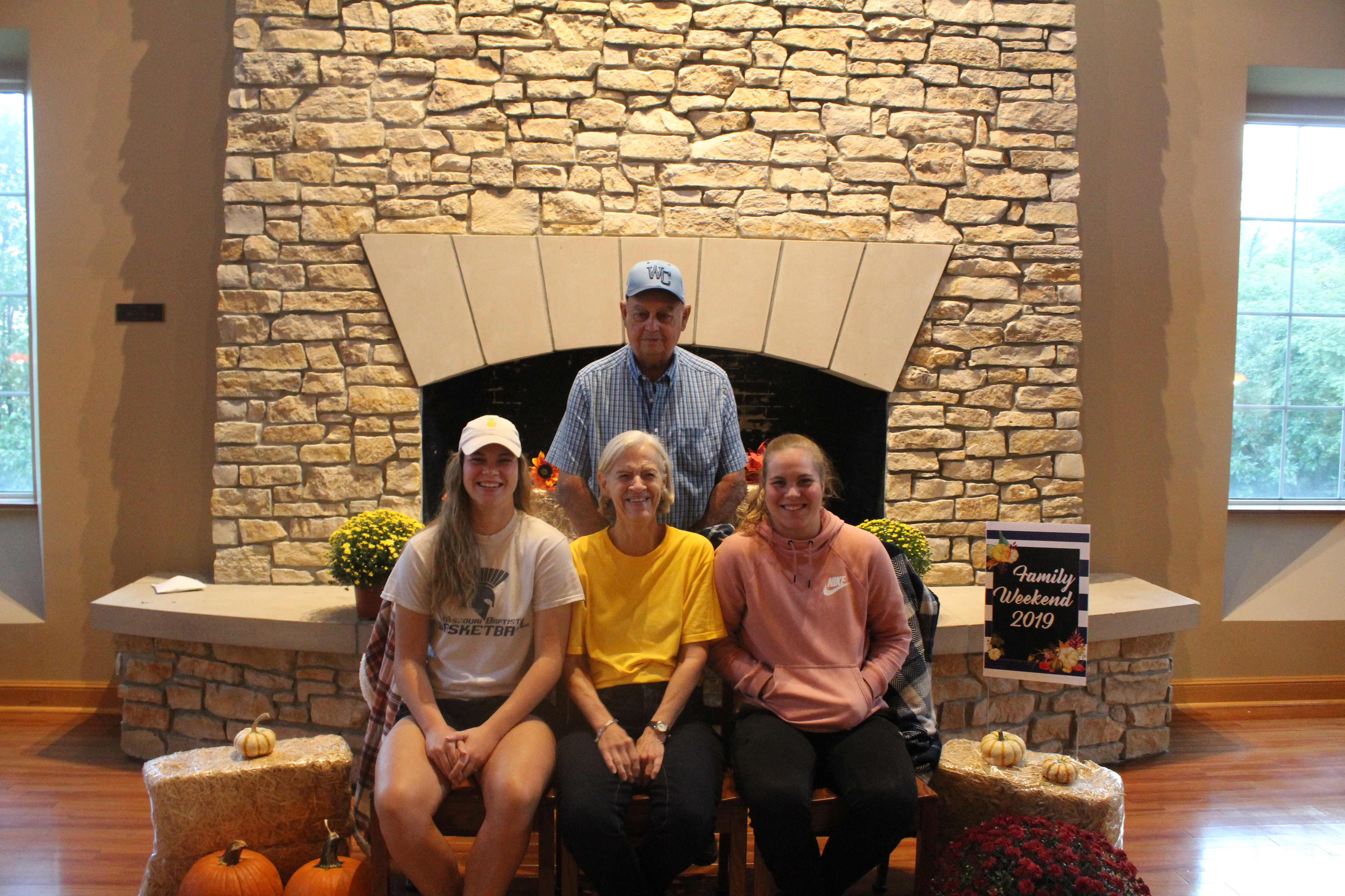 Two parents pose for a picture with two female Westminster College students during Family Weekend.