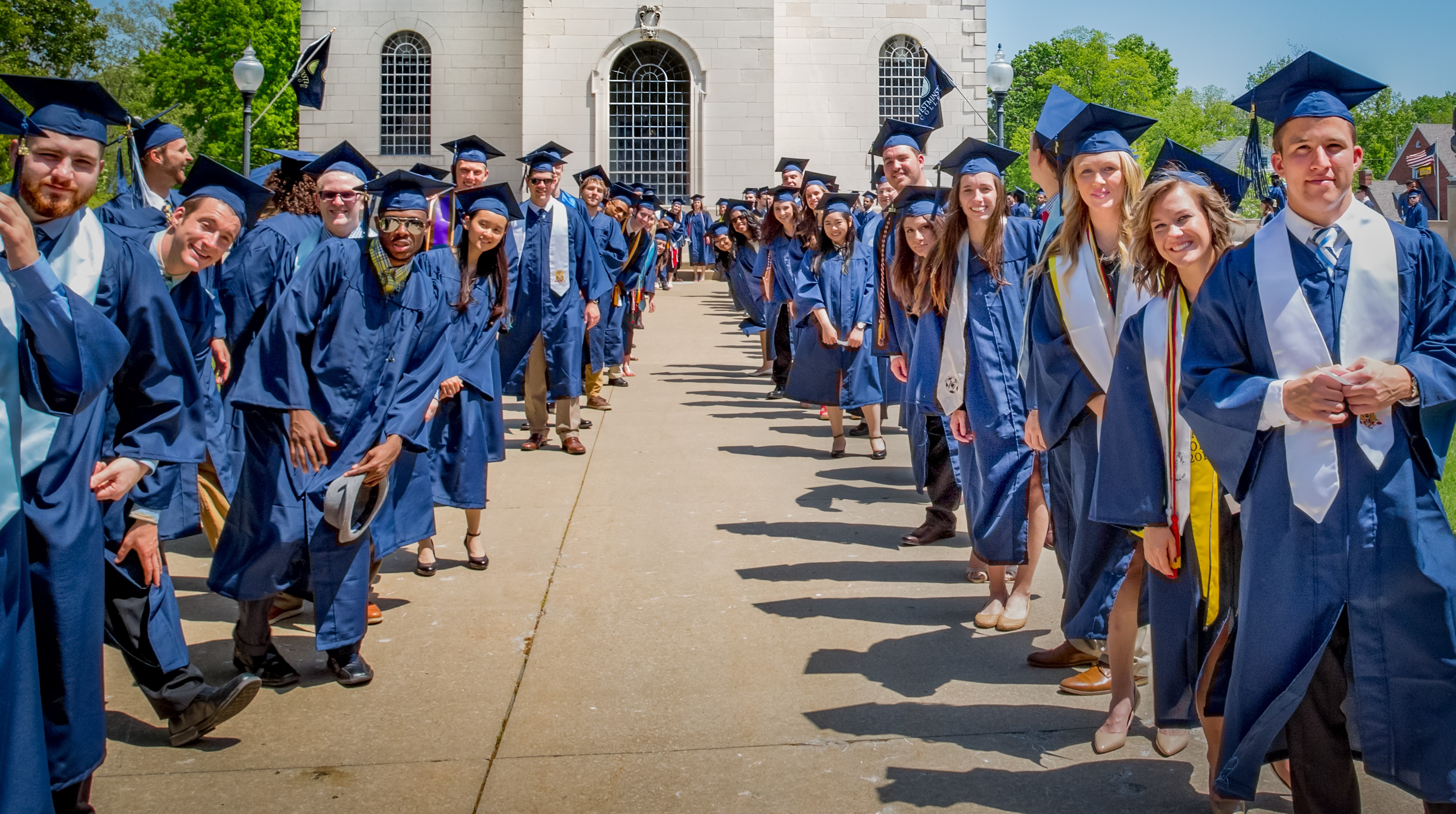 Students in Cap and gown looking at the camera