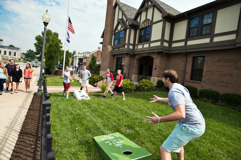 students playing cornhole