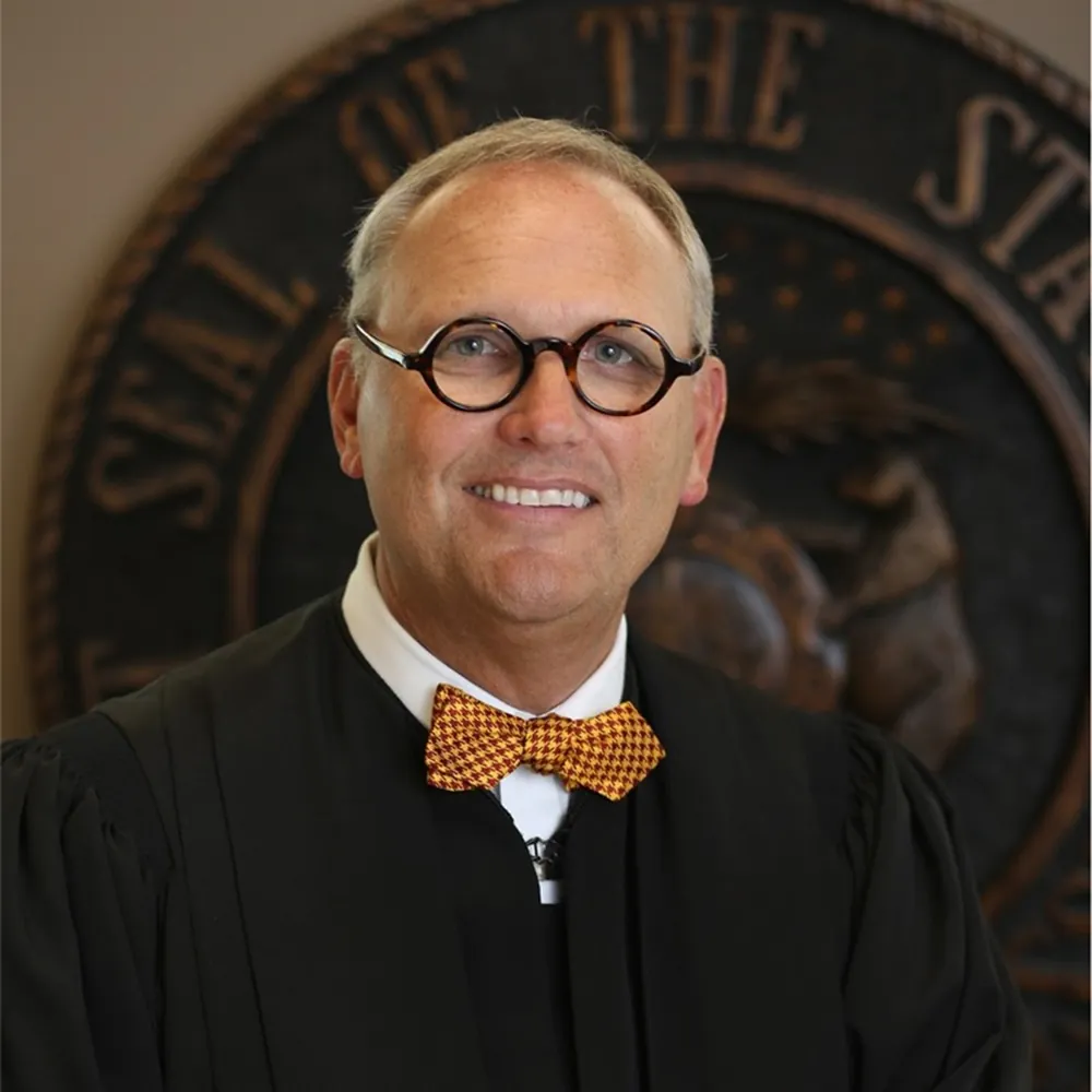 person in glasses and judge outfit